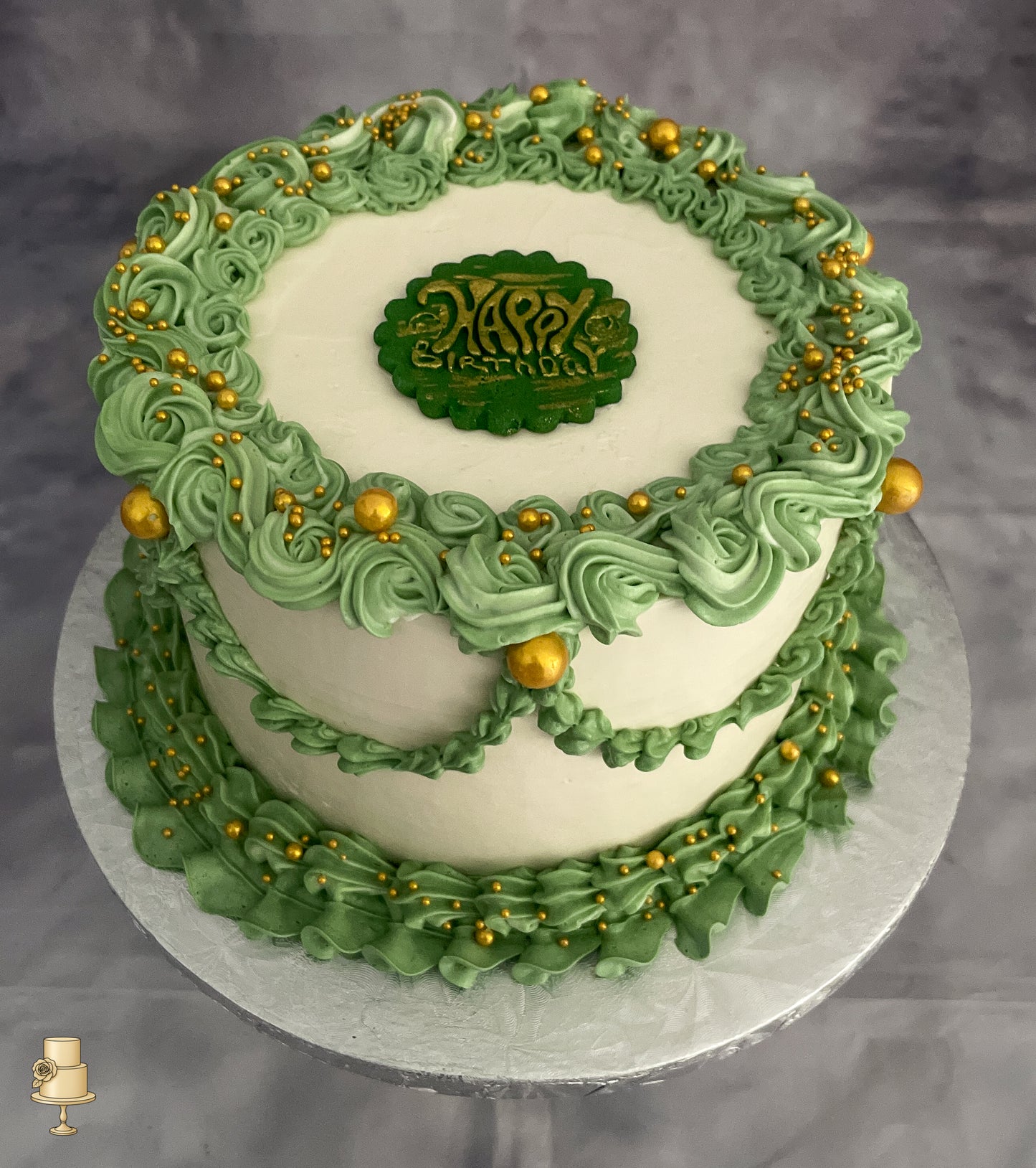 Green and white buttercream cake with gold decorations