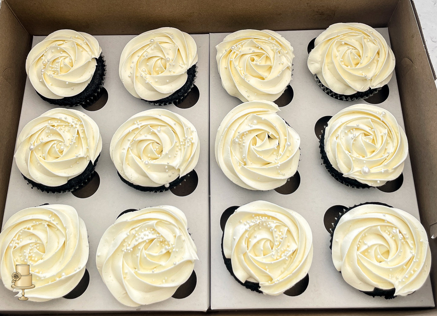 Box of cupcakes with white buttercream rosette frosting 