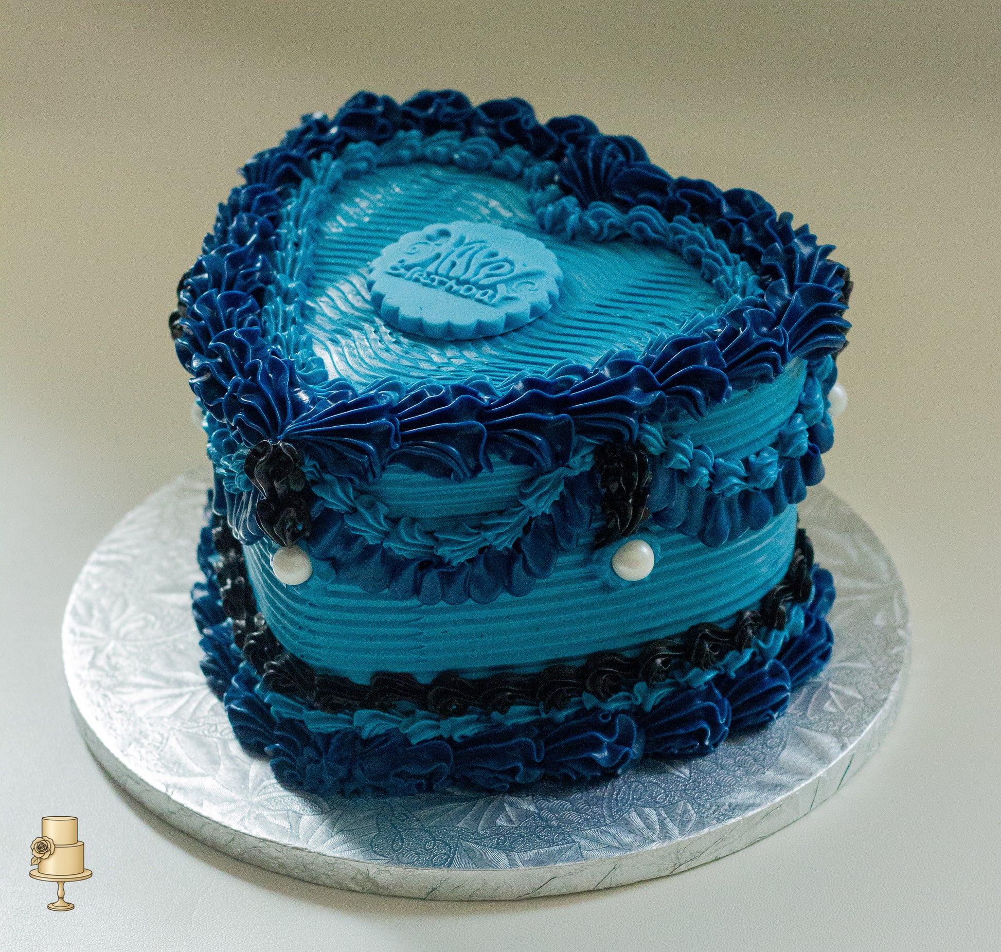 Blue vintage heart-shaped cake with ruffled frosting 